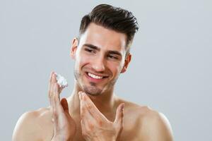 Man applying shaving cream photo