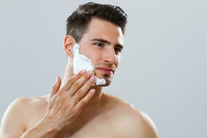 Man applying shaving cream photo