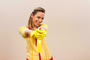 Portrait of happy housewife having fun while cleaning photo