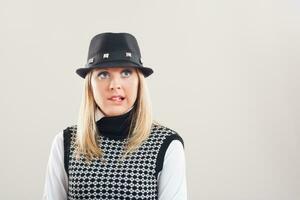 Woman with a hat and sweater thinking photo
