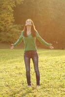 Happy woman enjoys in park photo