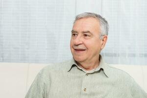 Portrait of happy senior man relaxing at home. photo