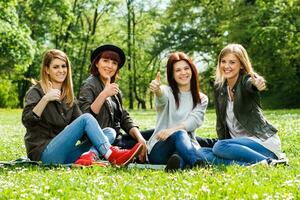 Young girls showing thumbs up photo