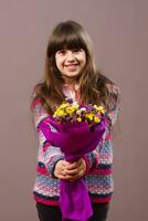 Cute little girl holding flowers photo