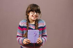 Little nerd girl holding gift photo