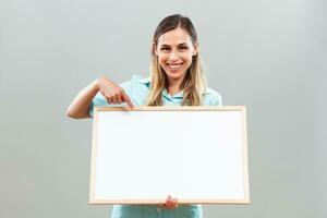 Beautiful nurse is pointing at whiteboard. photo