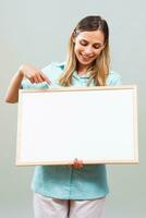 Beautiful nurse is pointing at whiteboard. photo