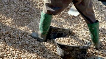 Construction worker preparing crushed stone for building house video