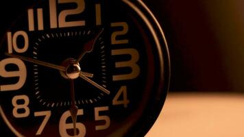 Close up of a black alarm clock, early morning video