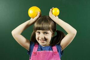 Happy little girl holding fruits photo