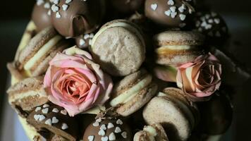 Cookies with roses lie on a cake with white icing. photo