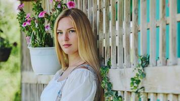 A girl of Slavic appearance poses at home with flowers. photo