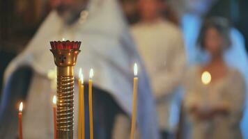 Burning candles in front of the priest at the wedding ceremony. photo