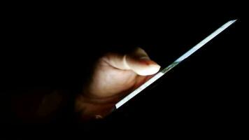 Hands operating mobile phones on black background video