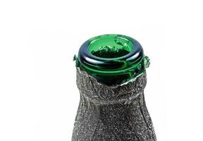 Neck of green bottle close-up on white background photo