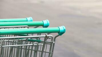 Close up view of shopping cart handles on dark background photo