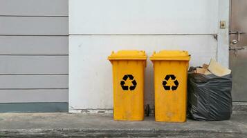 Yellow recycle bins on dark background photo