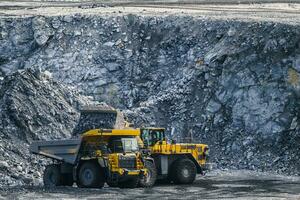 Loading stone with a wheel loader on a large truck. photo