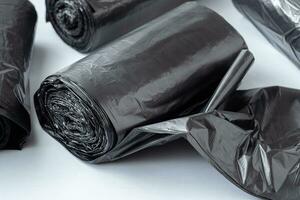 New black garbage bags on a white background. photo