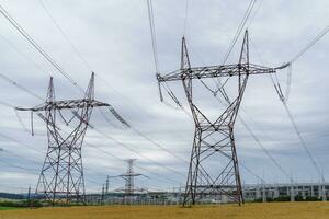 Distribution electric substation with power lines and transformers. High voltage power transformer substation. photo