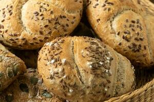 Wicker basket with selection of breads and pastries. Assortment of baked products photo