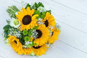 Wedding bouquet of sunflower on a wooden background. Top view with copy space. photo