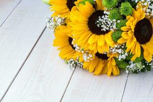 Wedding bouquet of sunflower on a wooden background. Top view with copy space. photo