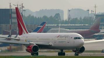 MOSCOW, RUSSIAN FEDERATION JULY 30, 2021 Commercial plane Boeing 767, VP BRE of Royal Flight Airlines taxiing at airport runway. Plane on the taxiway. Travel concept video