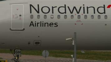 MOSCOW, RUSSIAN FEDERATION JULY 29, 2021 Civil airplane of Nordwind Airlines taxiing to the runway at Sheremetyevo airport, side view, middle shot. Footage of aircraft on the taxiway video