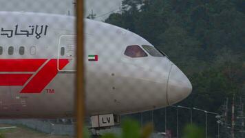 PHUKET, THAILAND JANUARY 26, 2023 Dreamliner Boeing 787 of Etihad Airways taxiing at Phuket airport. View through the fence. Formula One Abu Dhabi 2023 livery video