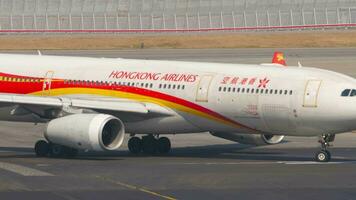 HONG KONG NOVEMBER 10, 2019 Airbus A330, B LNO of Hong Kong Airlines taxiing at Hong Kong Airport. Aircraft on taxiway. Tourism and travel concept video