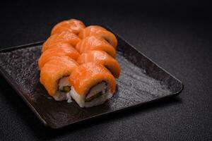 Delicious Philadelphia sushi roll with salmon, shrimp, cucumber and cream cheese photo