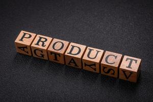 The inscription product with wooden cubes on a dark concrete background photo