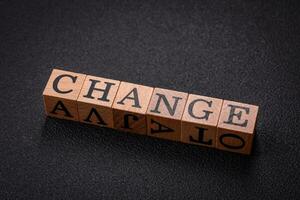 The inscription chance or change with wooden cubes on a dark concrete background photo