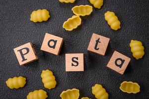 Raw durum wheat gnocchi pasta with salt and spices in a ceramic plate photo