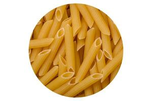 Raw penne pasta from whole grain wheat varieties with salt and spices photo