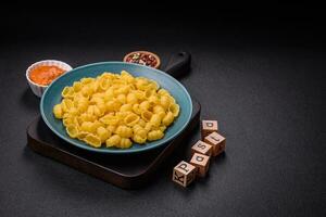 Raw durum wheat gnocchi pasta with salt and spices in a ceramic plate photo