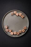 Beautiful Christmas composition with copy space with an inscription in wooden cubes photo