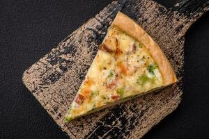 Delicious quiche with broccoli, cheese, chicken, spices and herbs photo