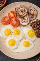 delicioso nutritivo desayuno de frito codorniz huevos, tocino, legumbres y Cereza Tomates foto