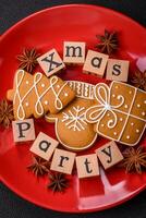 Christmas party inscription with wooden cubes on a dark concrete background photo