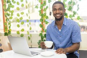 Photo of an adult man drinking coffee while having a break from work.