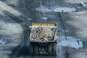 Dump truck in limestone mining, heavy machinery. Mining in the quarry. photo