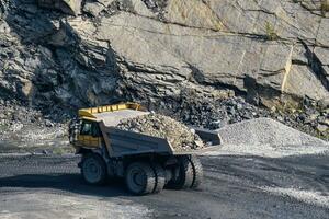 Dump truck in limestone mining, heavy machinery. Mining in the quarry. photo