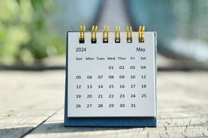 May 2024 white calendar with green blurred background. New year concept. photo