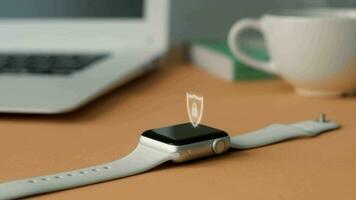 Displaying the shield icon on the smart watch screen which is on the office desk. video