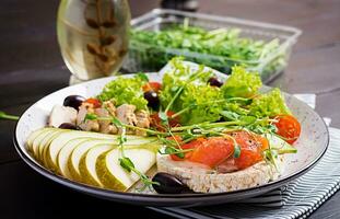 Healthy breakfast. Sandwiches with cream cheese,  salmon, avocado and slice pear on plate. photo