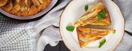 Homemade pie with pears and almond flour  on dark background. Top view, overhead photo