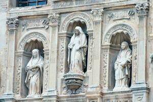 statues of jesus and mary on the facade of a building photo