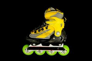 yellow and black inline skate on black photo